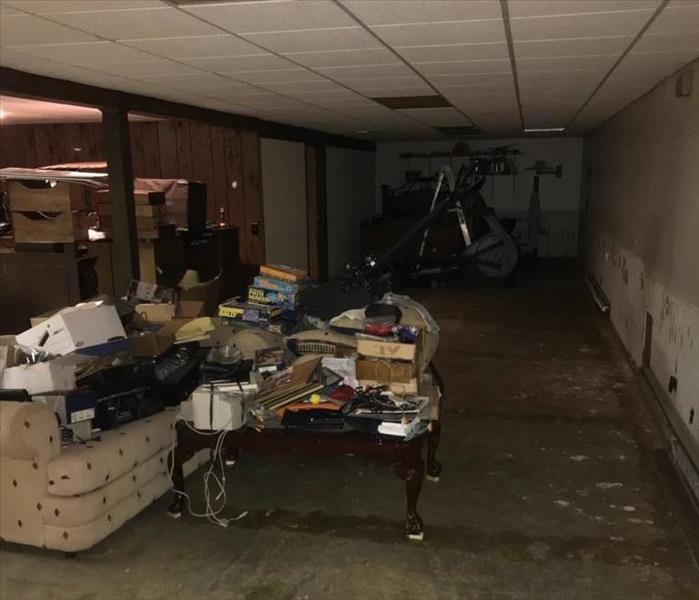Dirty basement with everything stacked to where it is not touching the  ground